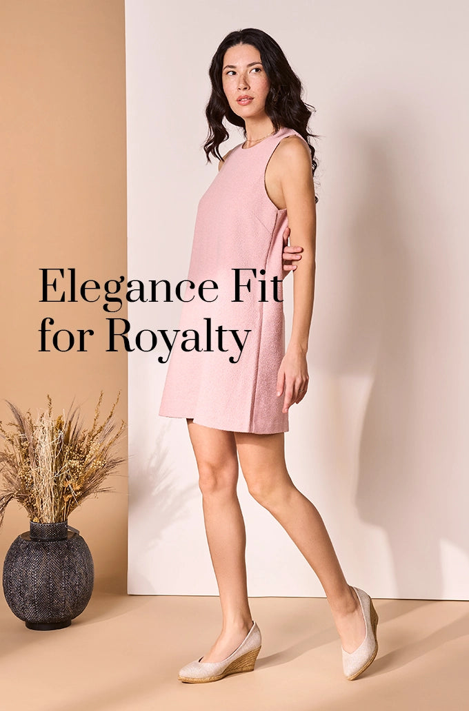 Woman wearing a sleeveless pink dress paired with silver wedge espadrilles, styled in an elegant indoor setting with neutral decor.