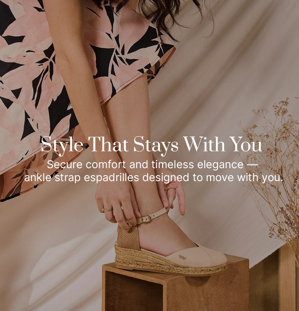 Close-up of woman fastening beige ankle-strap espadrille wedges by Viscata, handcrafted in Spain with jute soles, combining secure comfort and timeless Mediterranean style