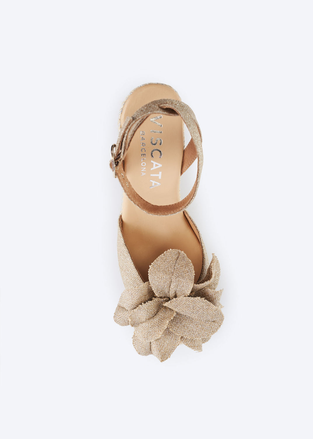 Silver metallic espadrille wedge sandal with oversized bow detail and ankle strap viewed from above.