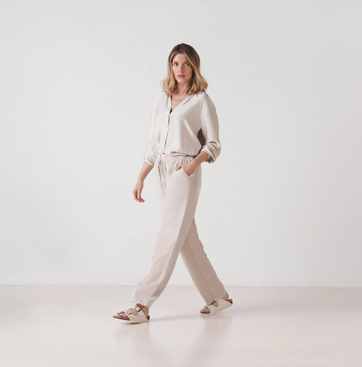 Beige espadrille sandals with woven jute platform sole styled with linen for effortless summer walks