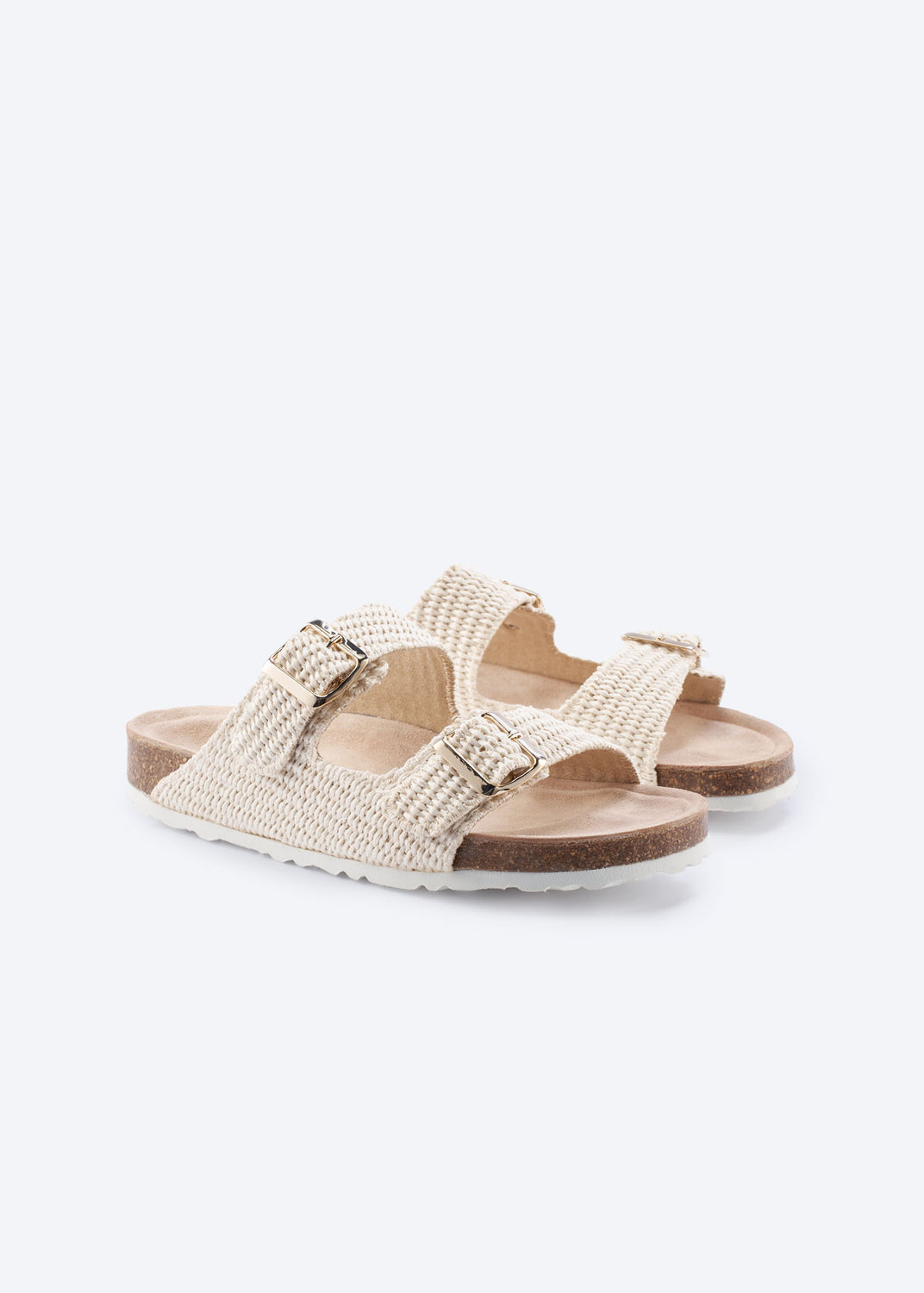 Pair of natural raffia double-buckle slide sandals, angled view.