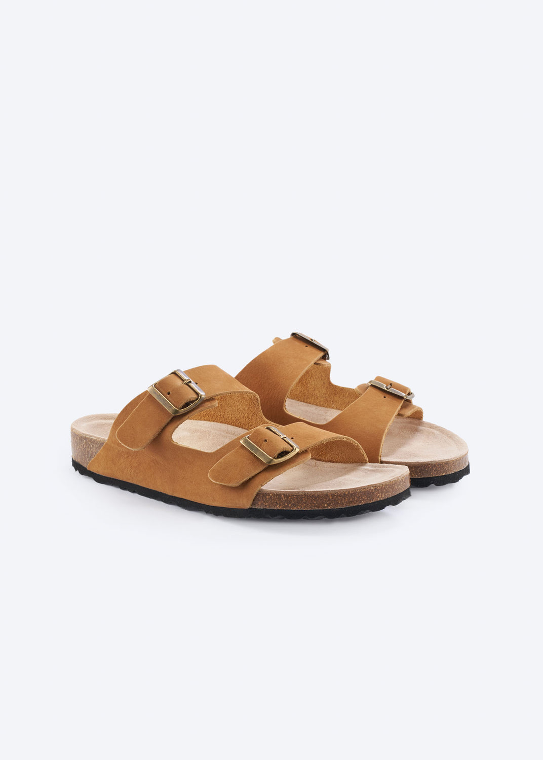 Pair of camel suede double-buckle slide sandals, angled view.