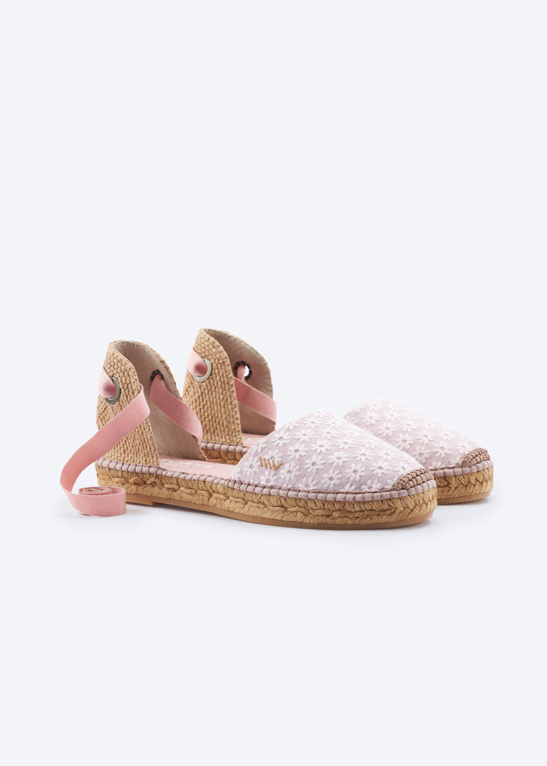 Daisy pink espadrille flats with wraparound ankle ties and embroidered floral detail on a clean background.