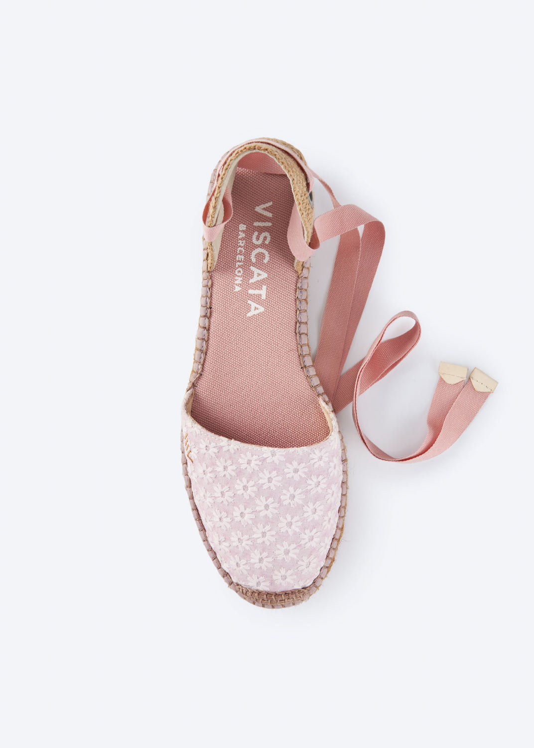 Top view of daisy pink espadrille flat with wraparound ankle ties and embroidered floral detail.