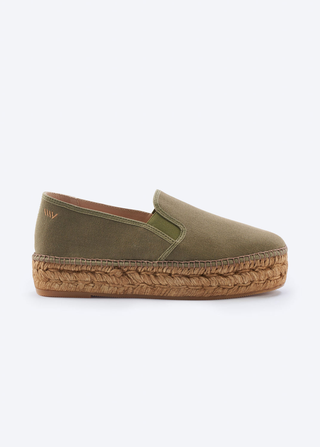 Side view of olive green espadrille flatforms with side gore detail and a natural braided jute platform sole, handcrafted in Spain