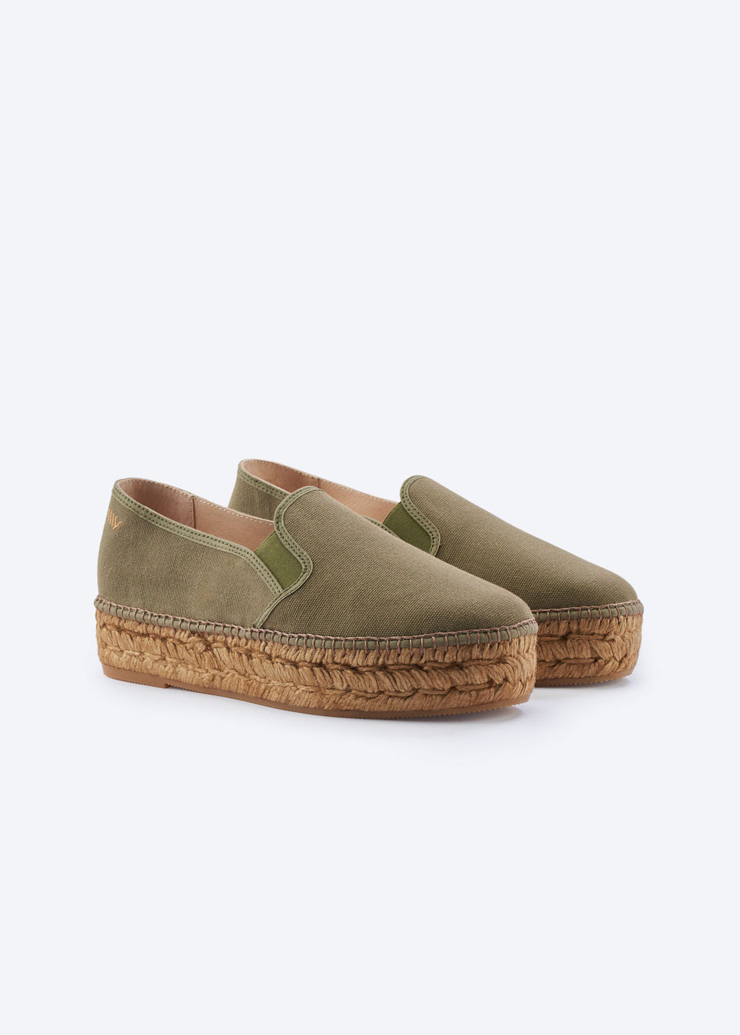 Olive green espadrille flats with side gore detail and a natural braided jute platform sole, handcrafted in Spain