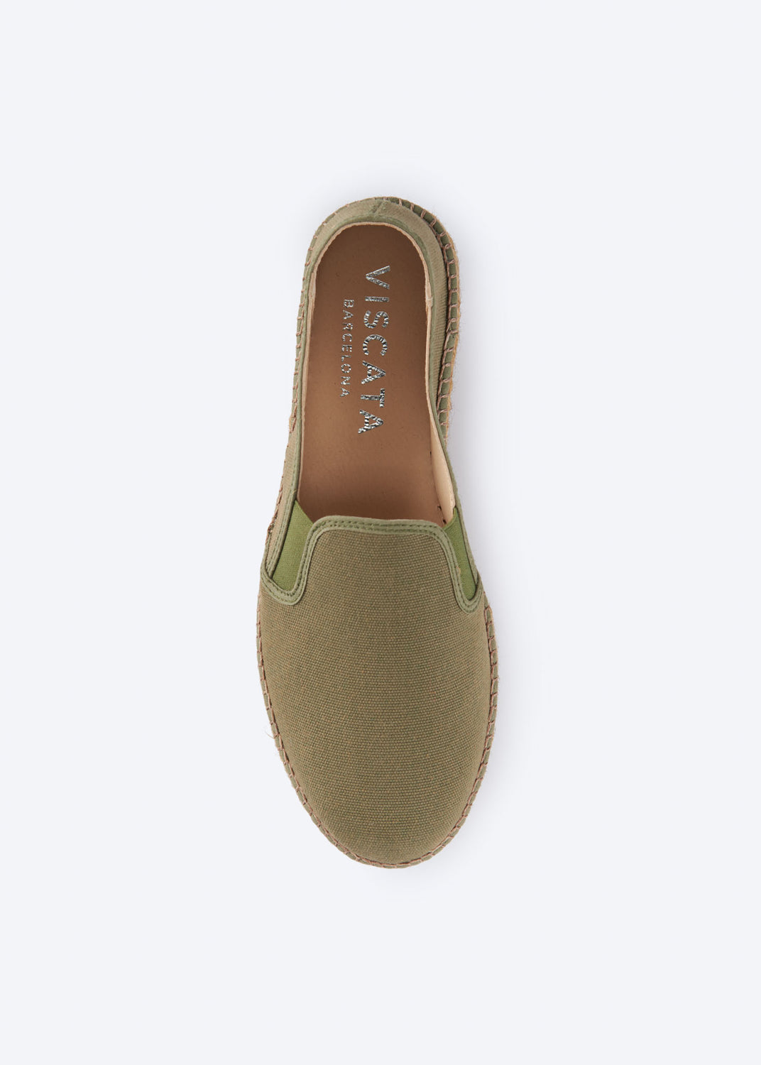 Top view of olive green espadrille flat with side gore detail and a natural braided jute platform sole, handcrafted in Spain