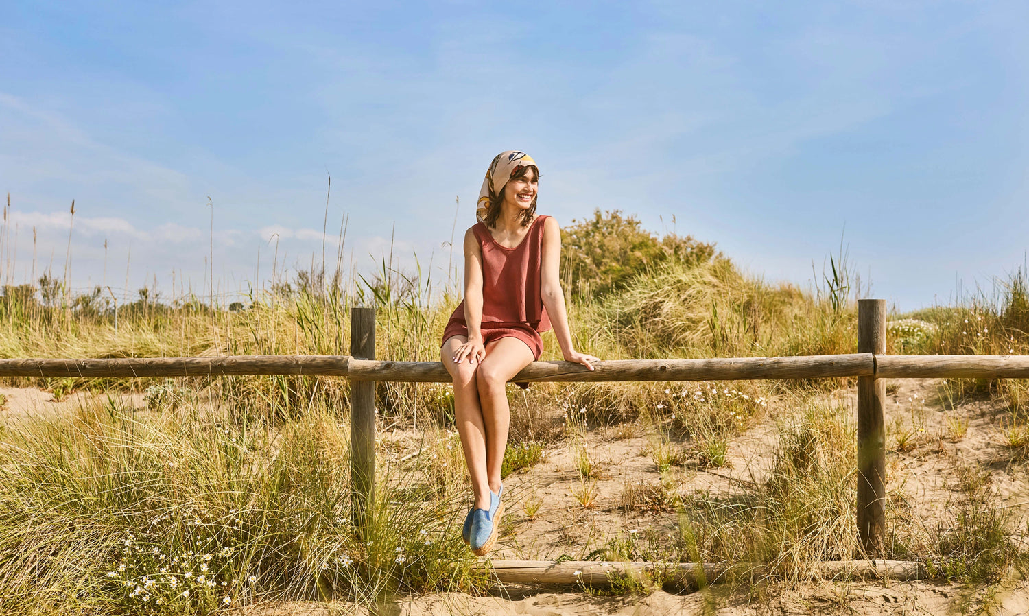 Blue canvas espadrille flats with woven jute soles styled on sunlit dunes for a relaxed Mediterranean summer day