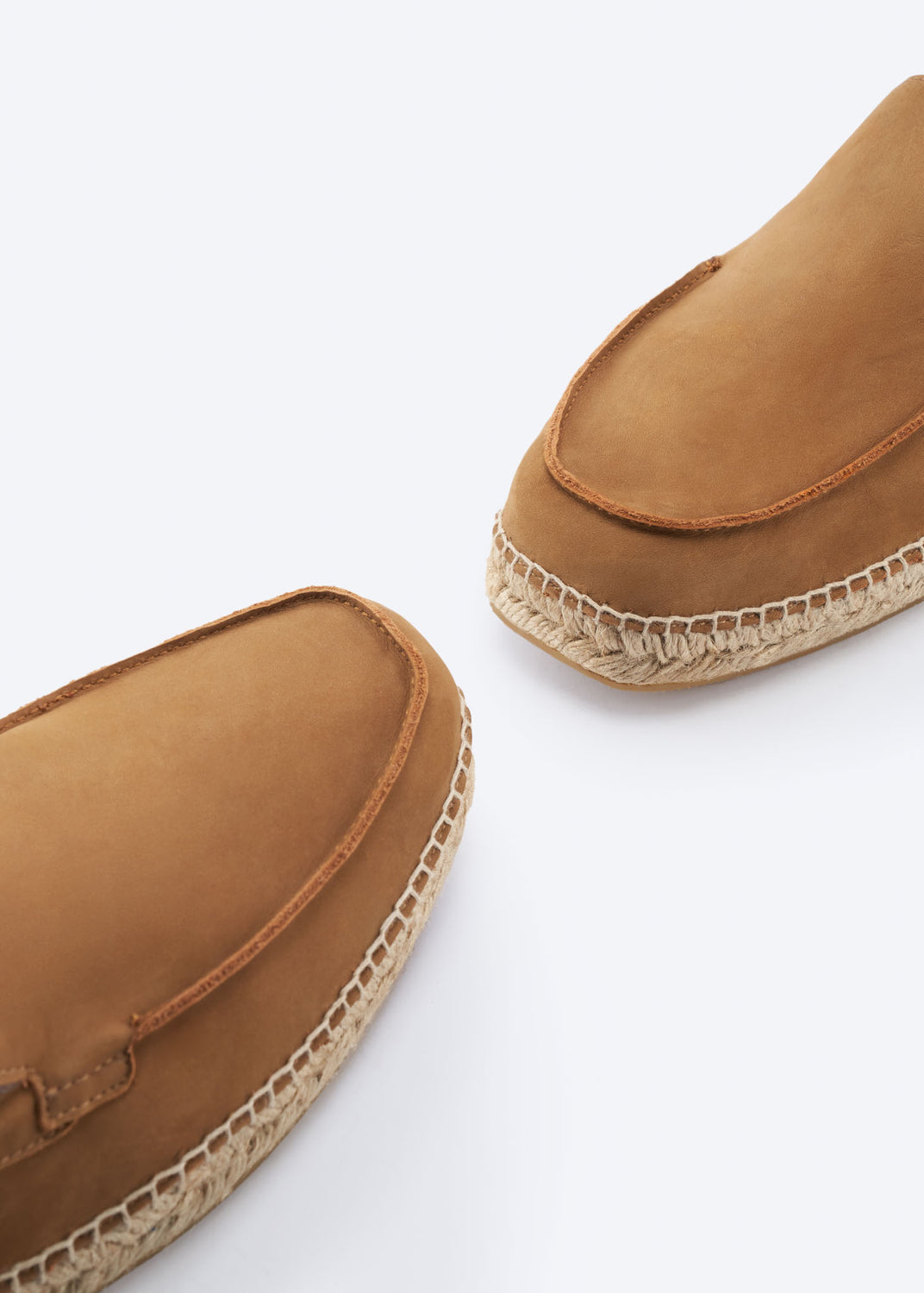 Close-up of camel suede espadrille loafers with jute sole.