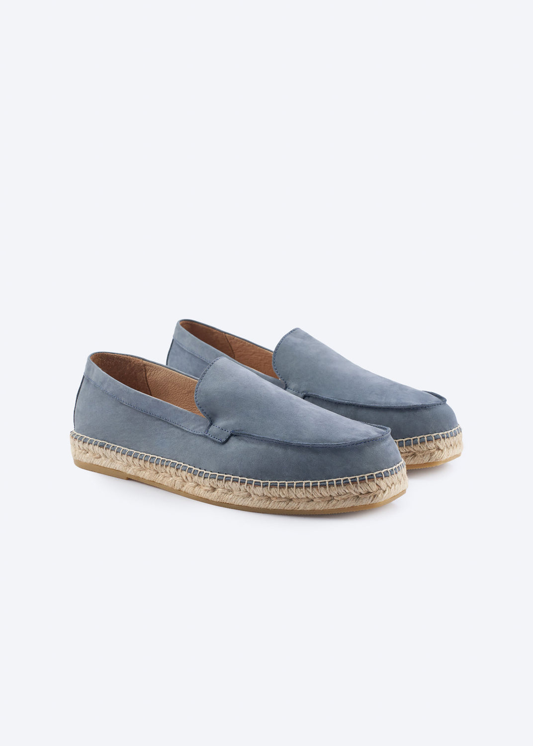 Pair of navy blue suede espadrille loafers, angled view.