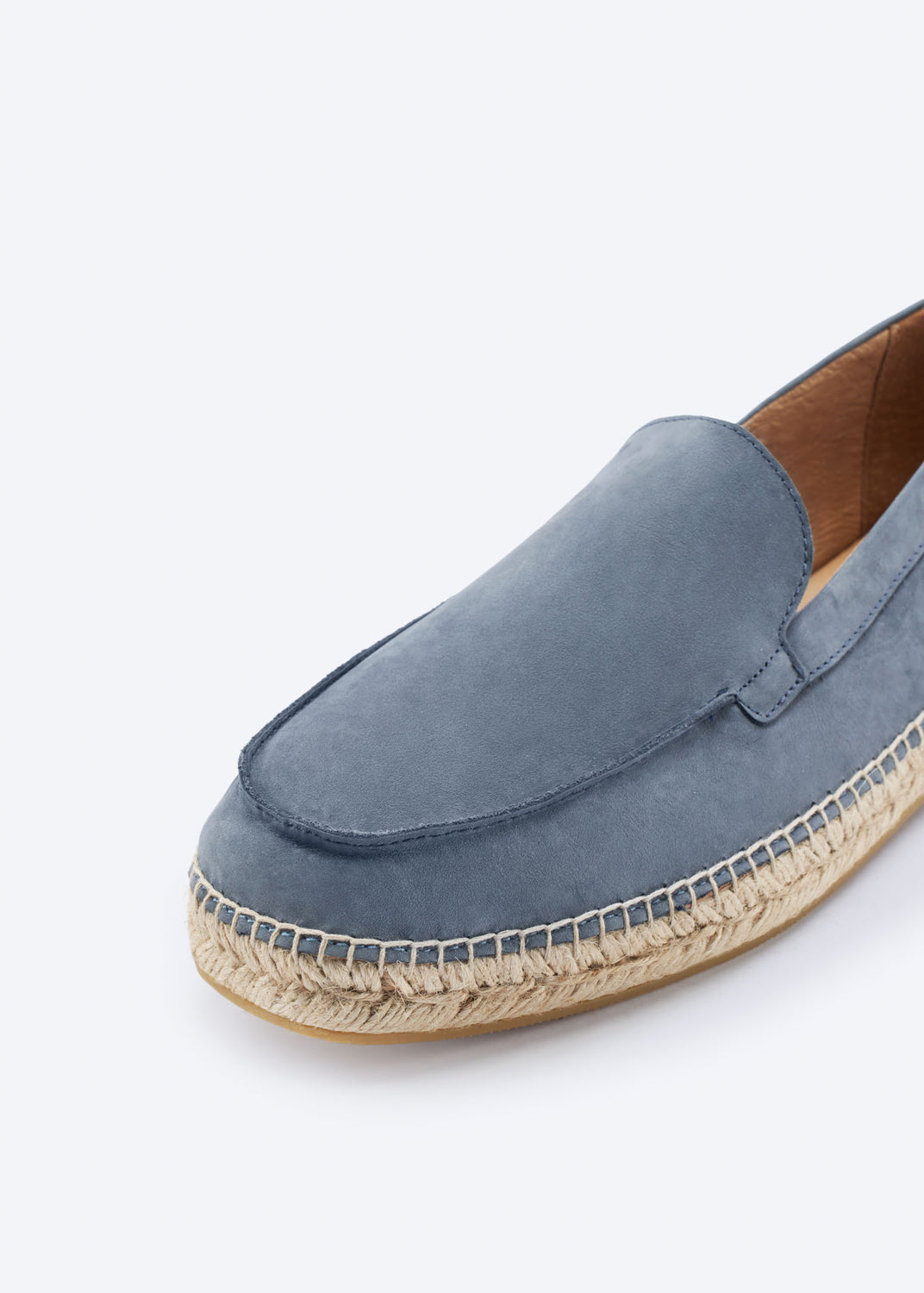 Close-up of a navy blue suede espadrille loafer with jute sole.
