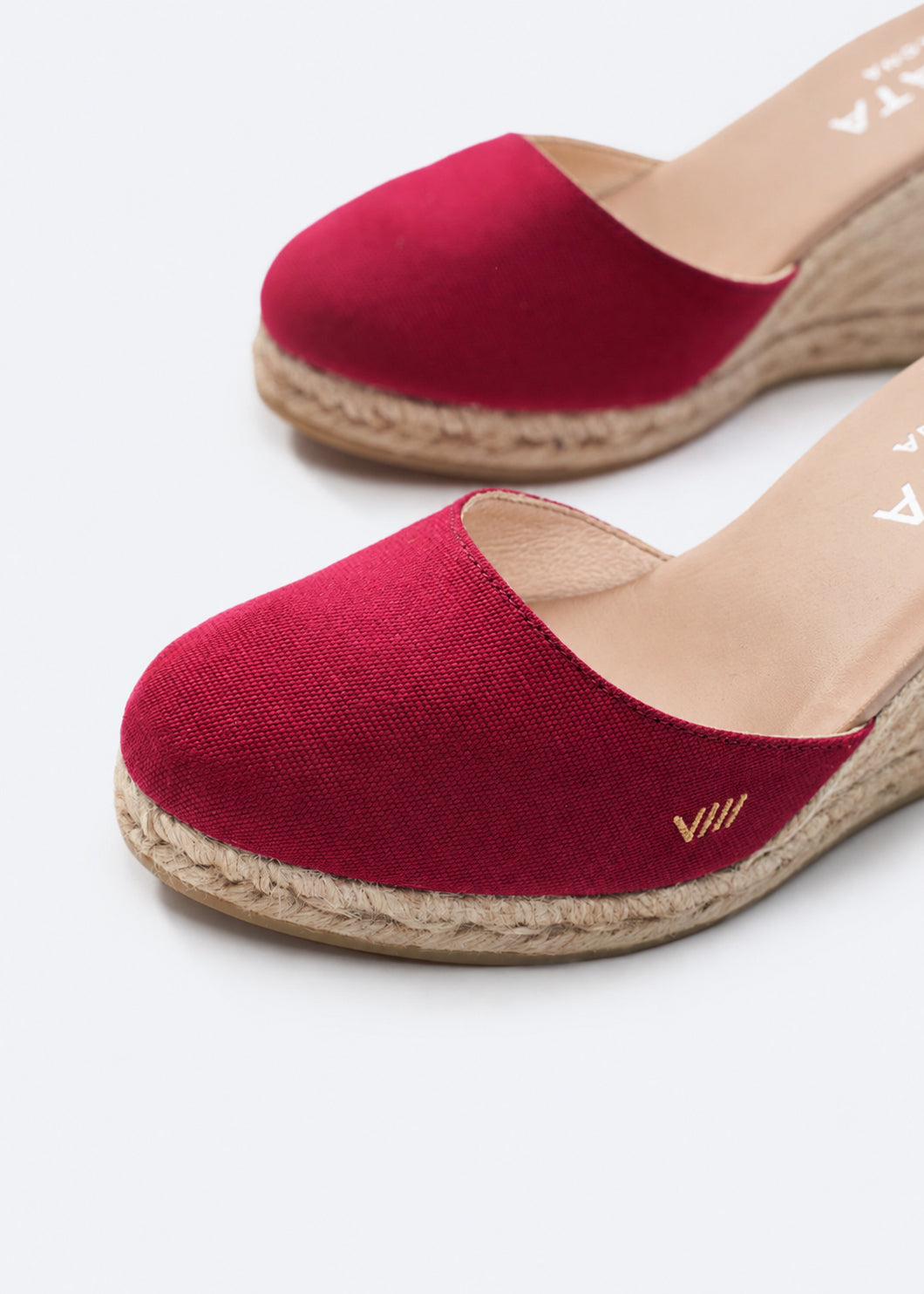 Red espadrille shoes on a white background