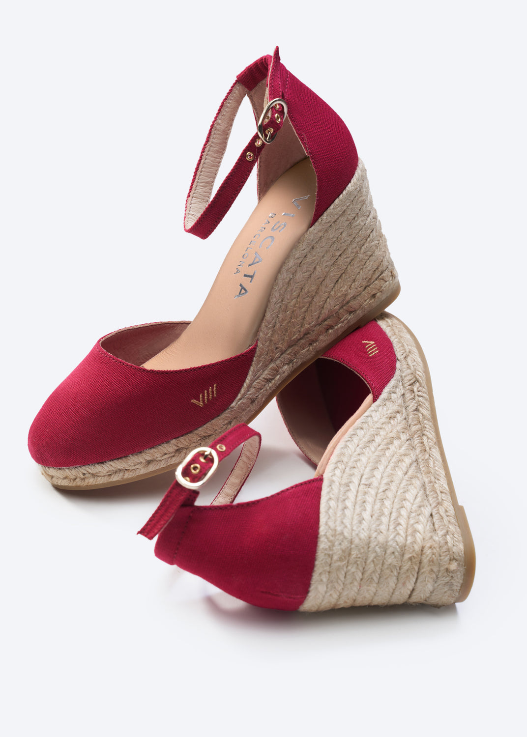 Red wedge sandals with jute sole on a white background