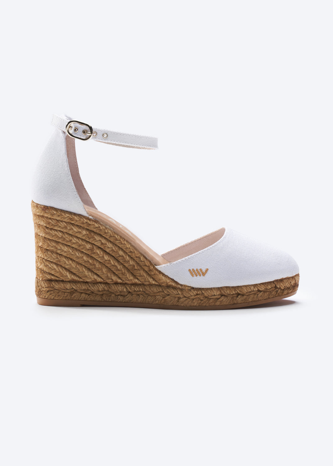 White wedge sandal with brown sole on a white background