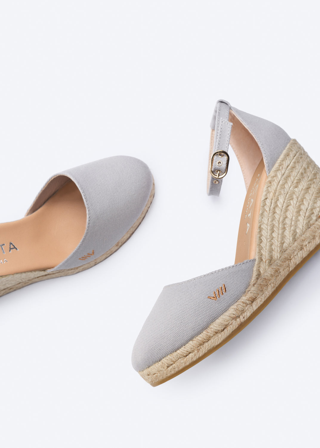 Gray wedge sandals with espadrille sole on a white background