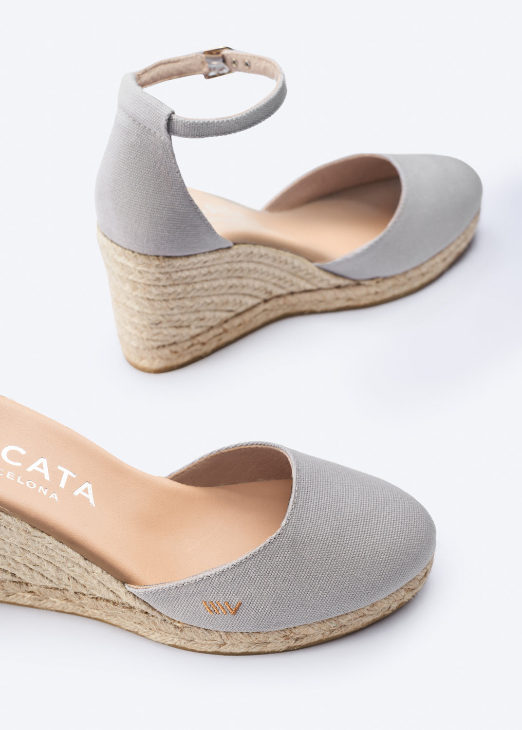 Gray wedge sandals with espadrille sole on a white background