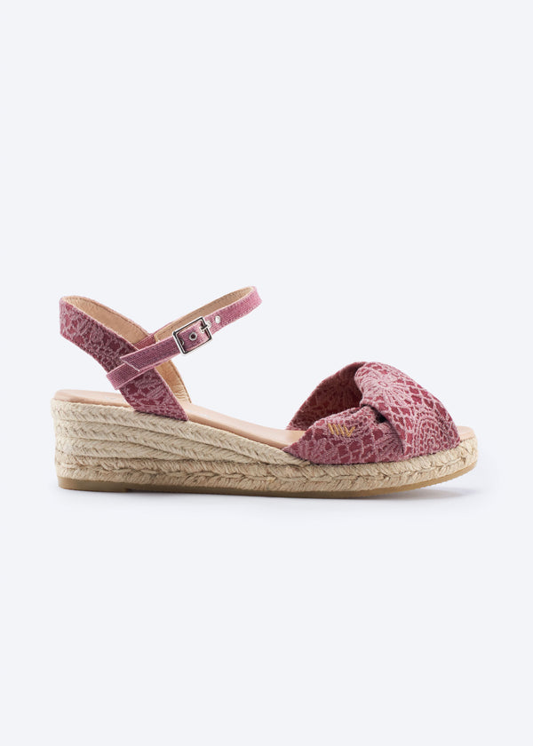 Side view of burgundy pink crochet espadrille sandal with ankle strap and braided jute sole.