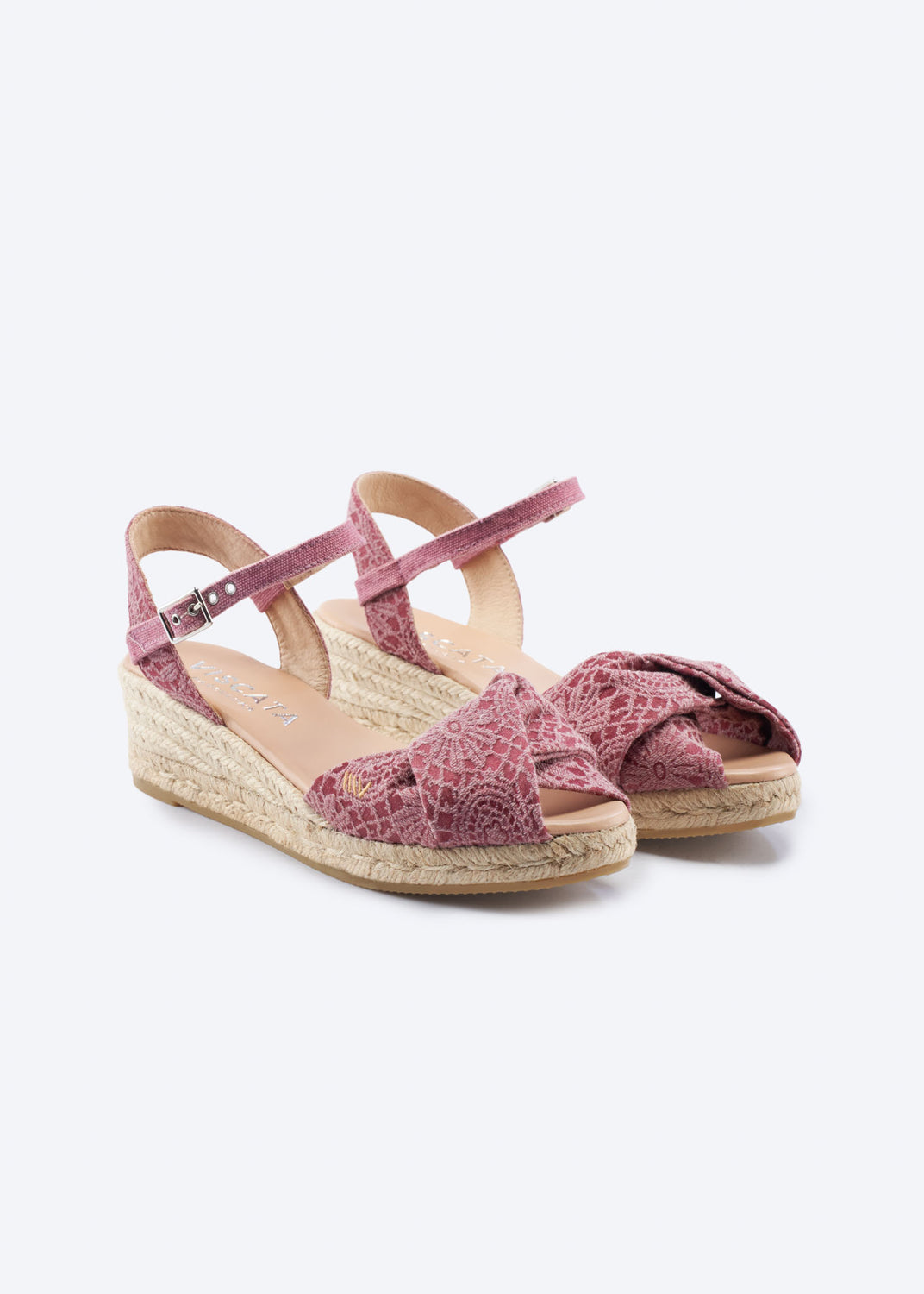 Pink crochet espadrille sandals with knotted front detail and ankle strap on a clean neutral background.