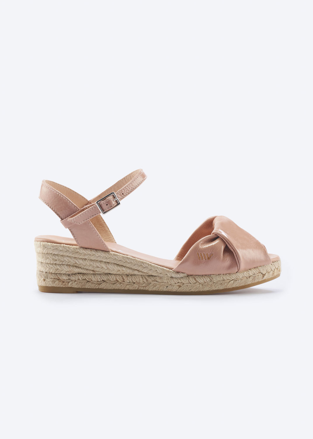 Side view of pink leather espadrille sandal with knotted front detail and braided jute sole.