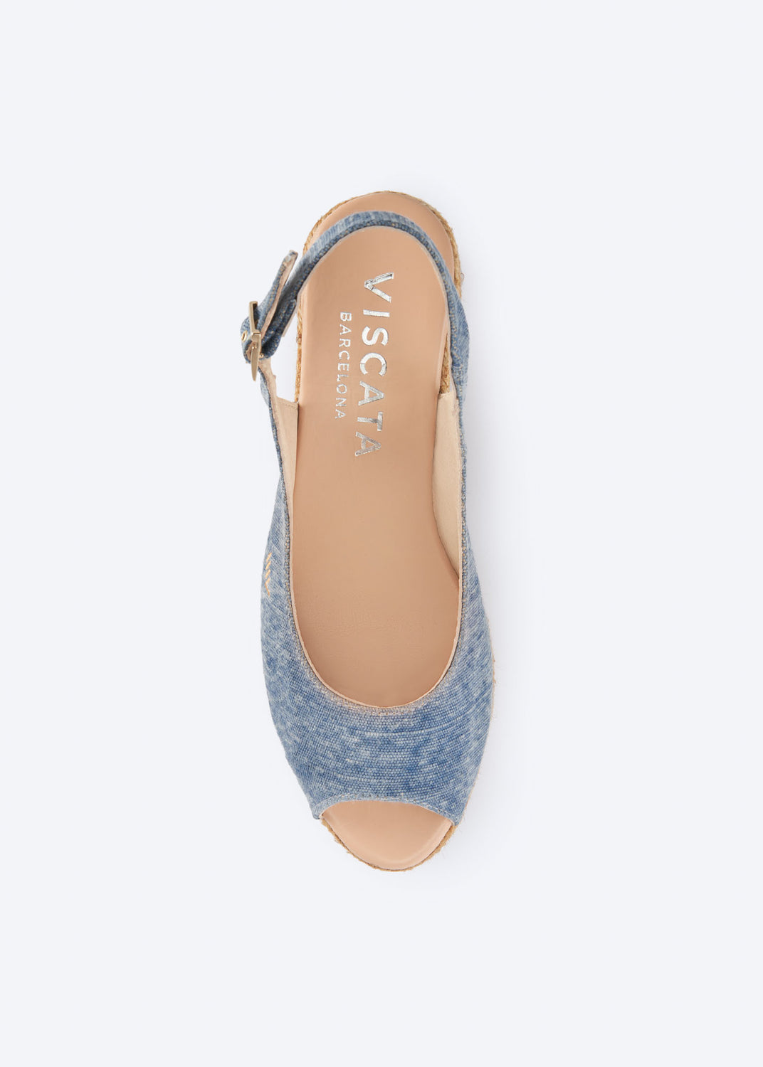 Top view of washed denim wedge espadrille sandal with slingback strap, open toe, and natural braided jute wedge, handcrafted in Spain