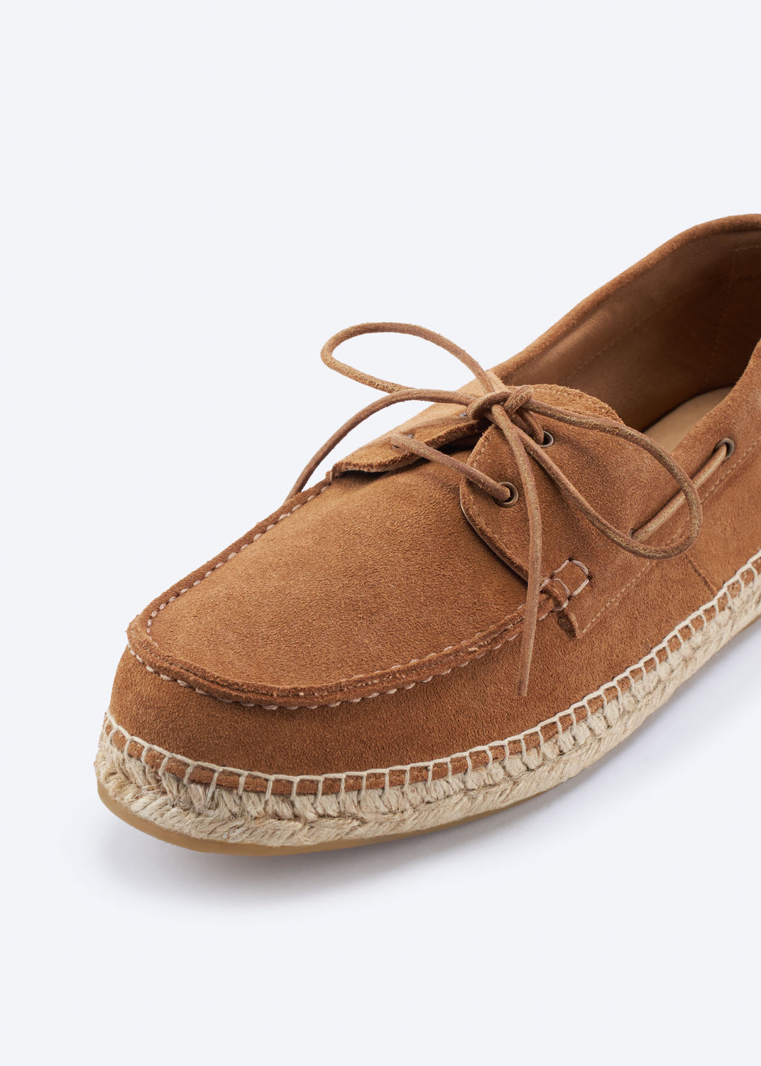 Close-up of a men’s tan suede espadrille boat shoe with lace detail, moc-toe stitching, and hand-finished jute-wrapped sole.