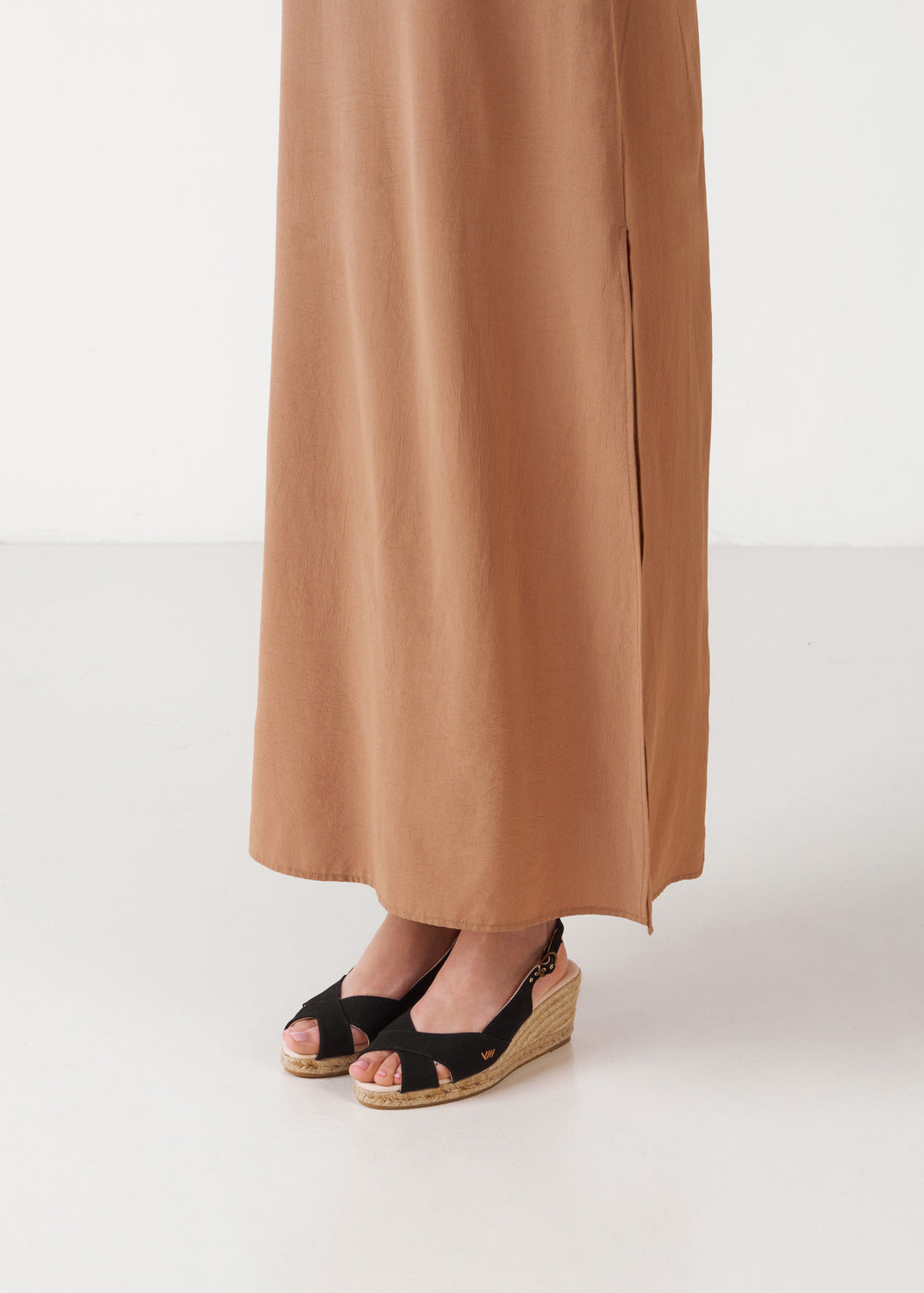 Black canvas slingback sandal wedge espadrilles with a natural jute platform, styled with a neutral maxi dress