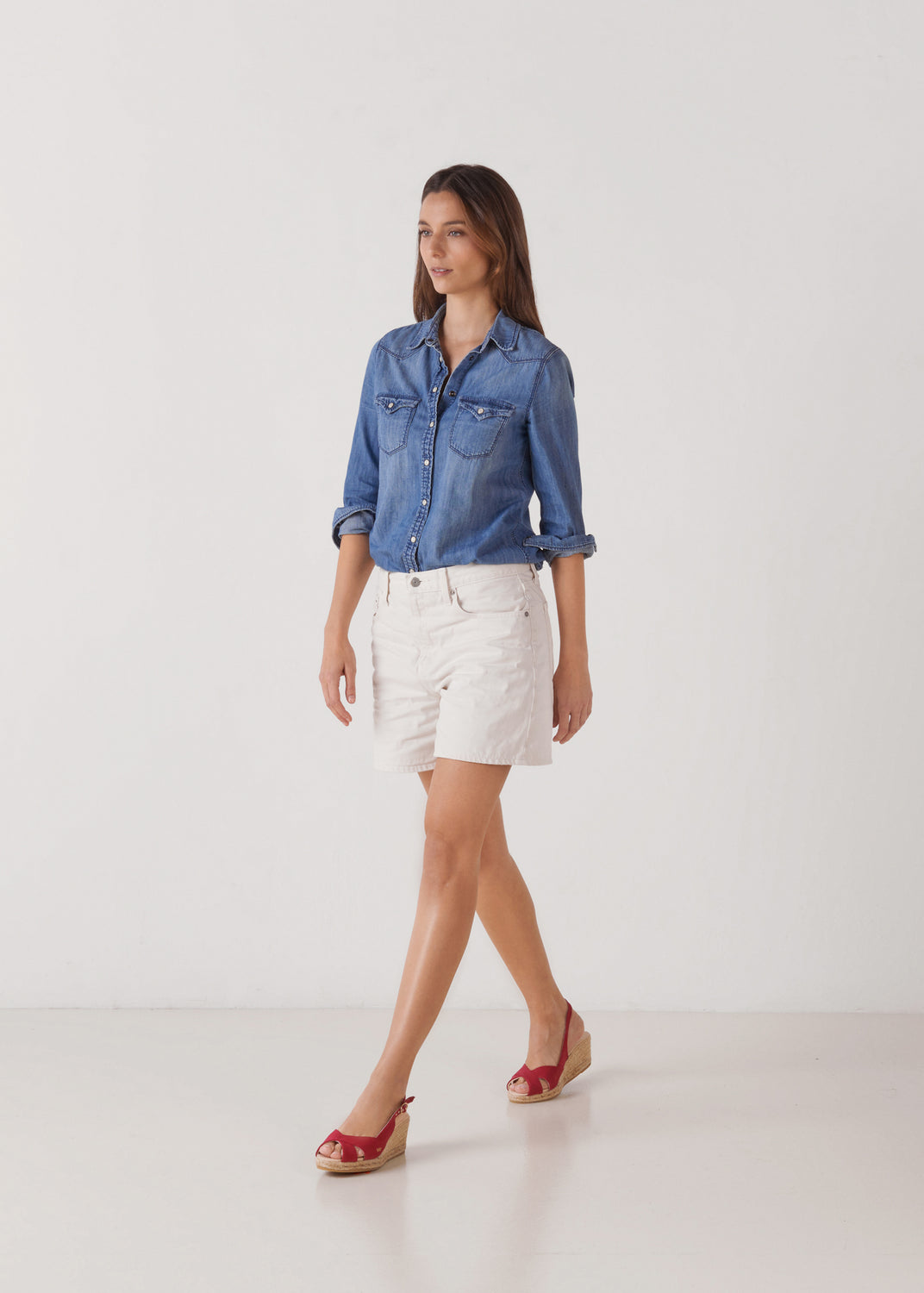 Model walking in cherry canvas slingback sandal wedge espadrilles with a natural jute platform