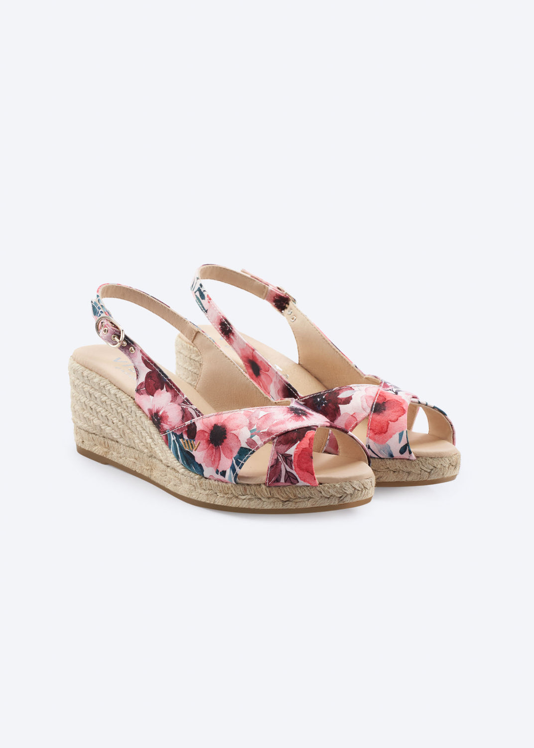Floral print wedge espadrille sandals with crossover front straps, slingback straps, and a natural braided jute wedge, handcrafted in Spain