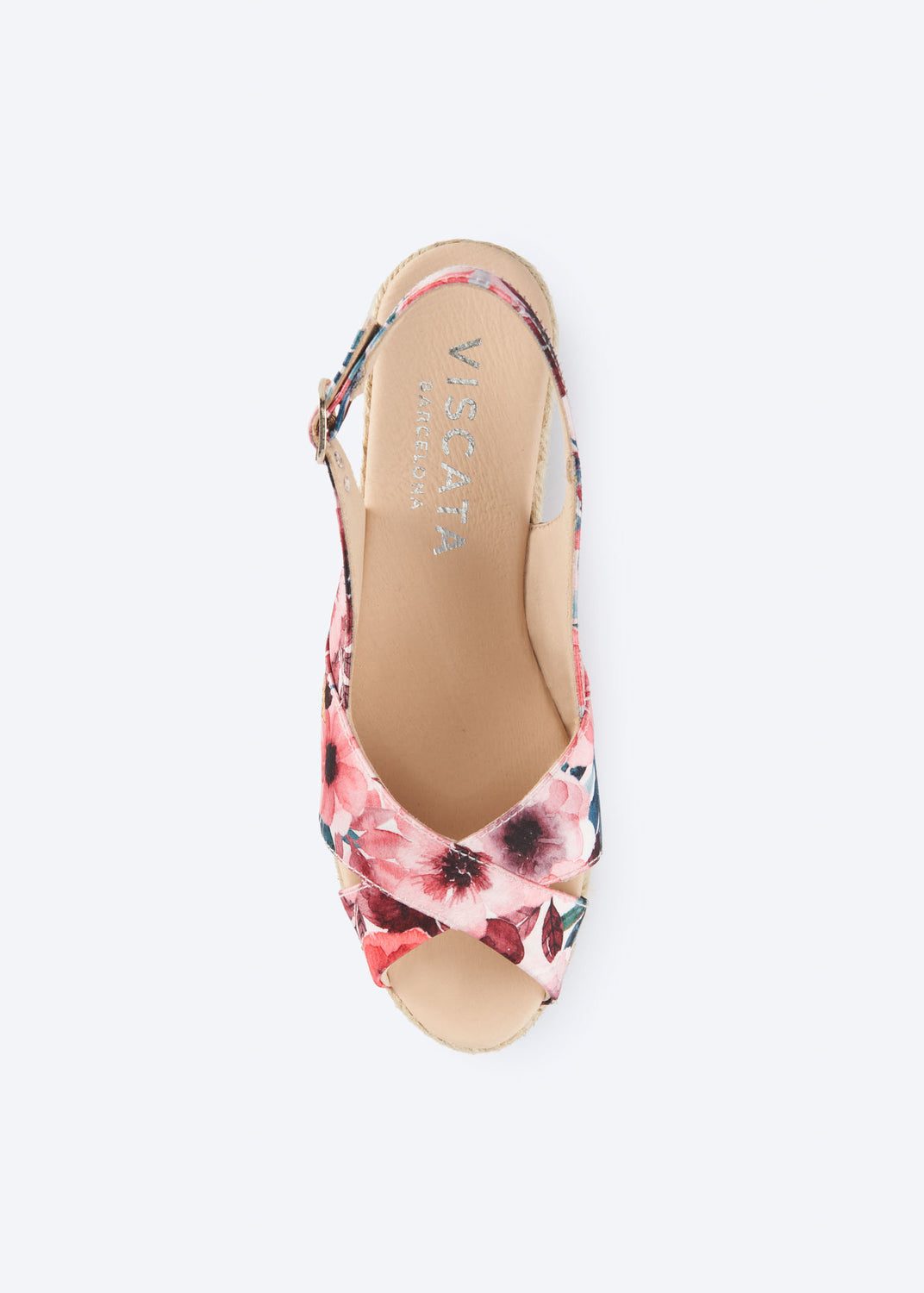 Top view of floral print wedge espadrille sandal with crossover front straps, slingback strap, and natural braided jute wedge, handcrafted in Spain