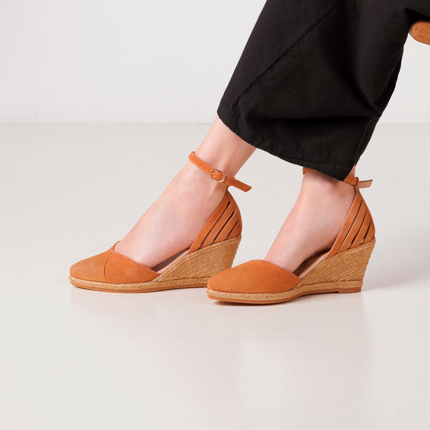 On-foot studio shot of tan suede espadrille wedge shoes with ankle strap and jute-wrapped sole