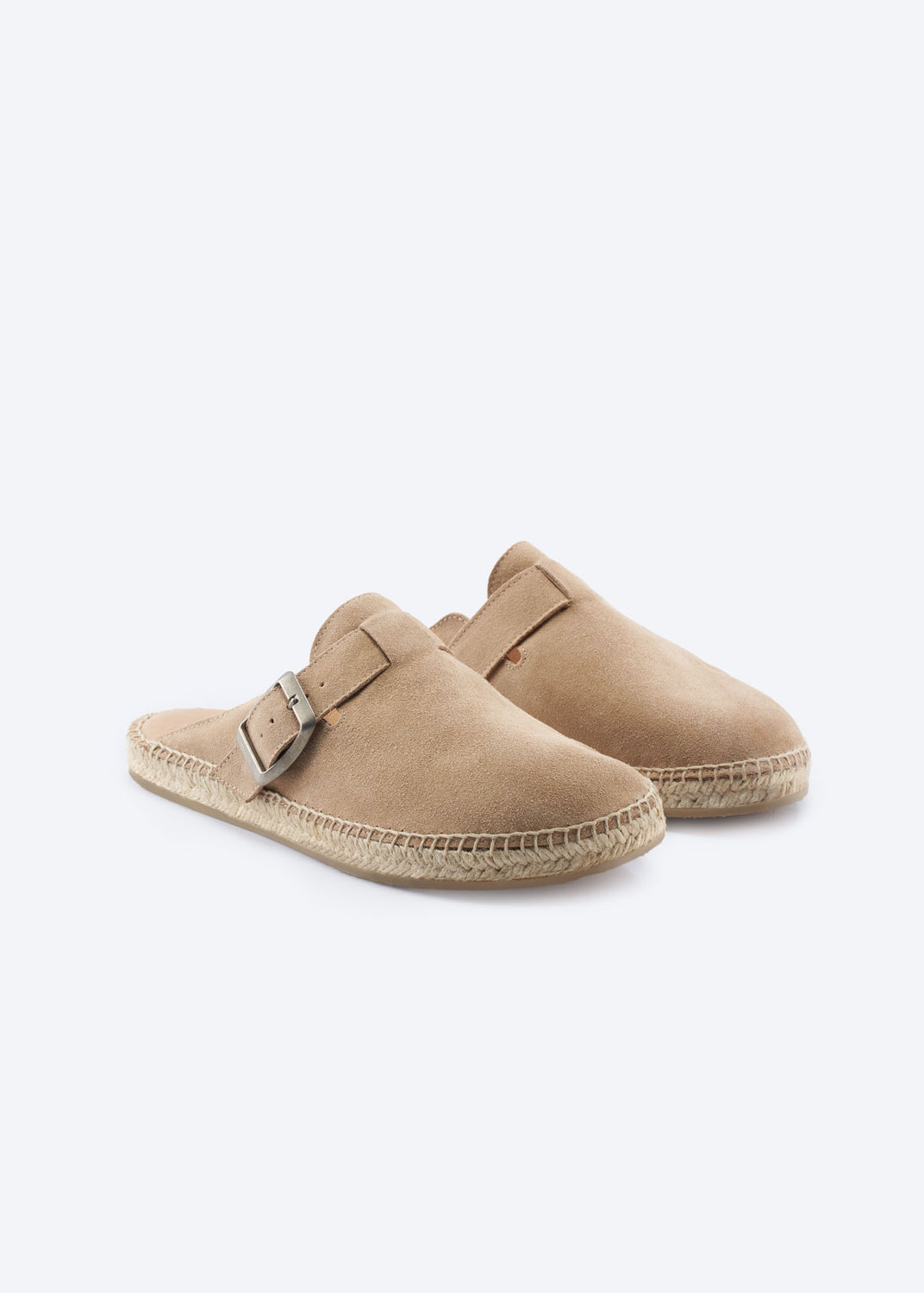 Pair of camel suede espadrille clogs with buckle, angled view.