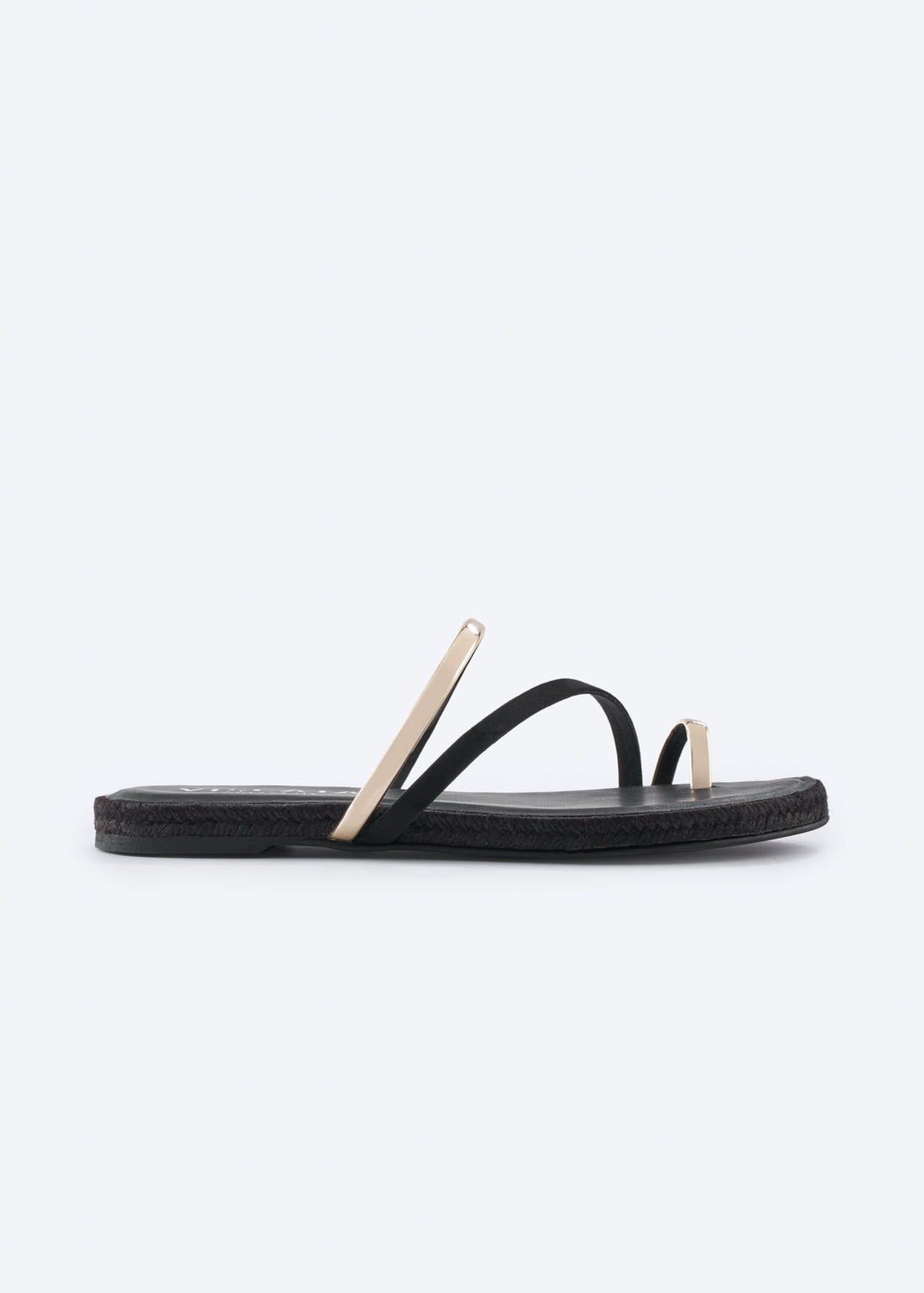 Side profile of a black flat sandal with gold-tone straps.