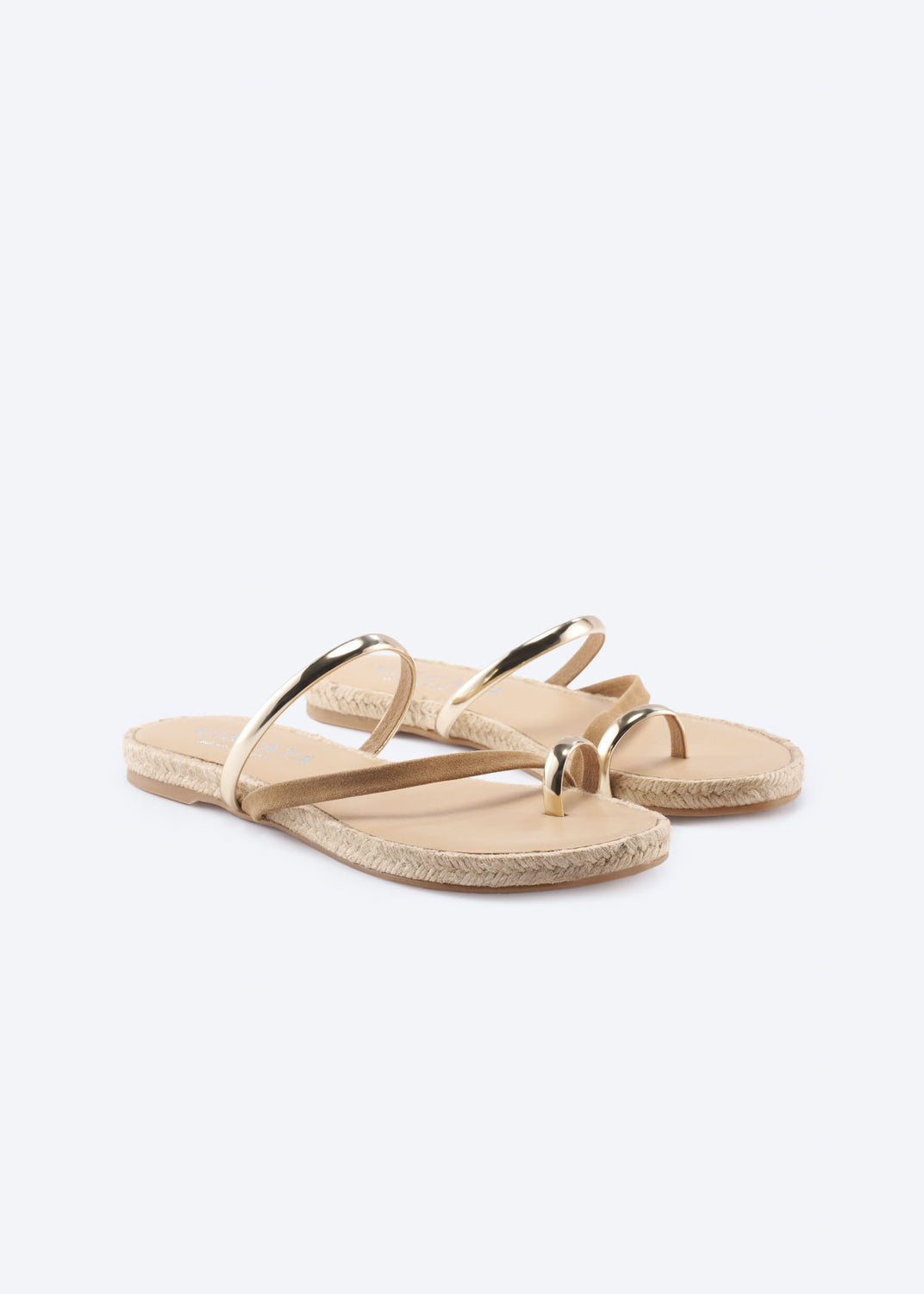 Pair of tan suede flat sandals with metallic straps, angled view.
