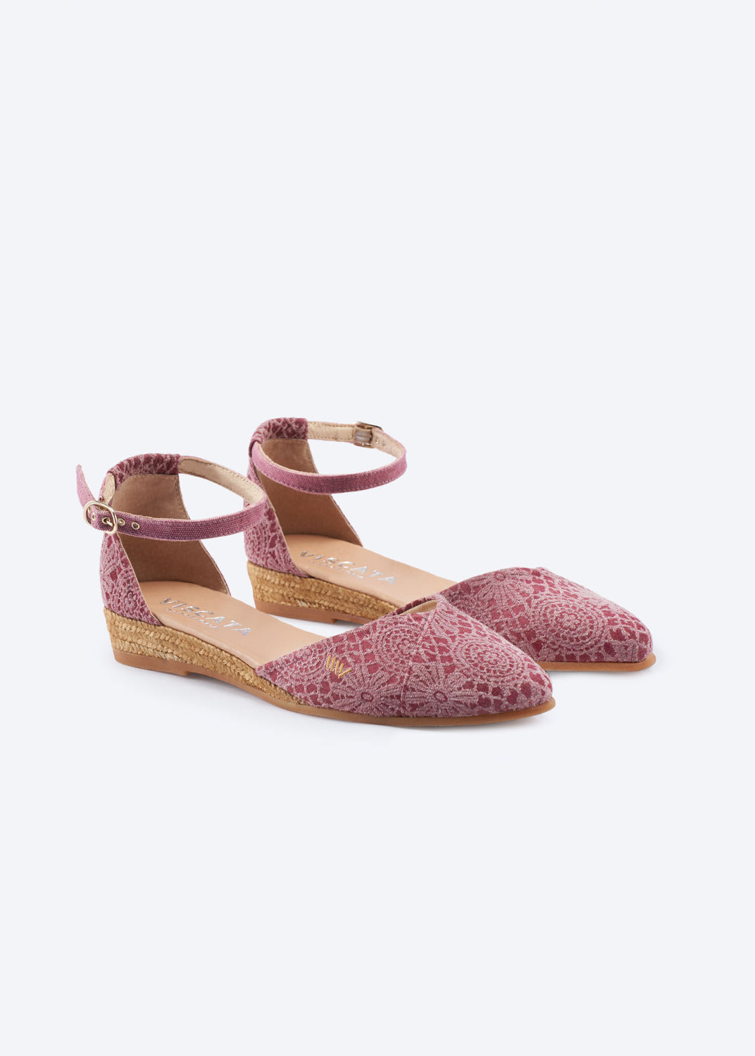 Pink crochet espadrille flats with ankle strap and low wedge on a clean neutral background.