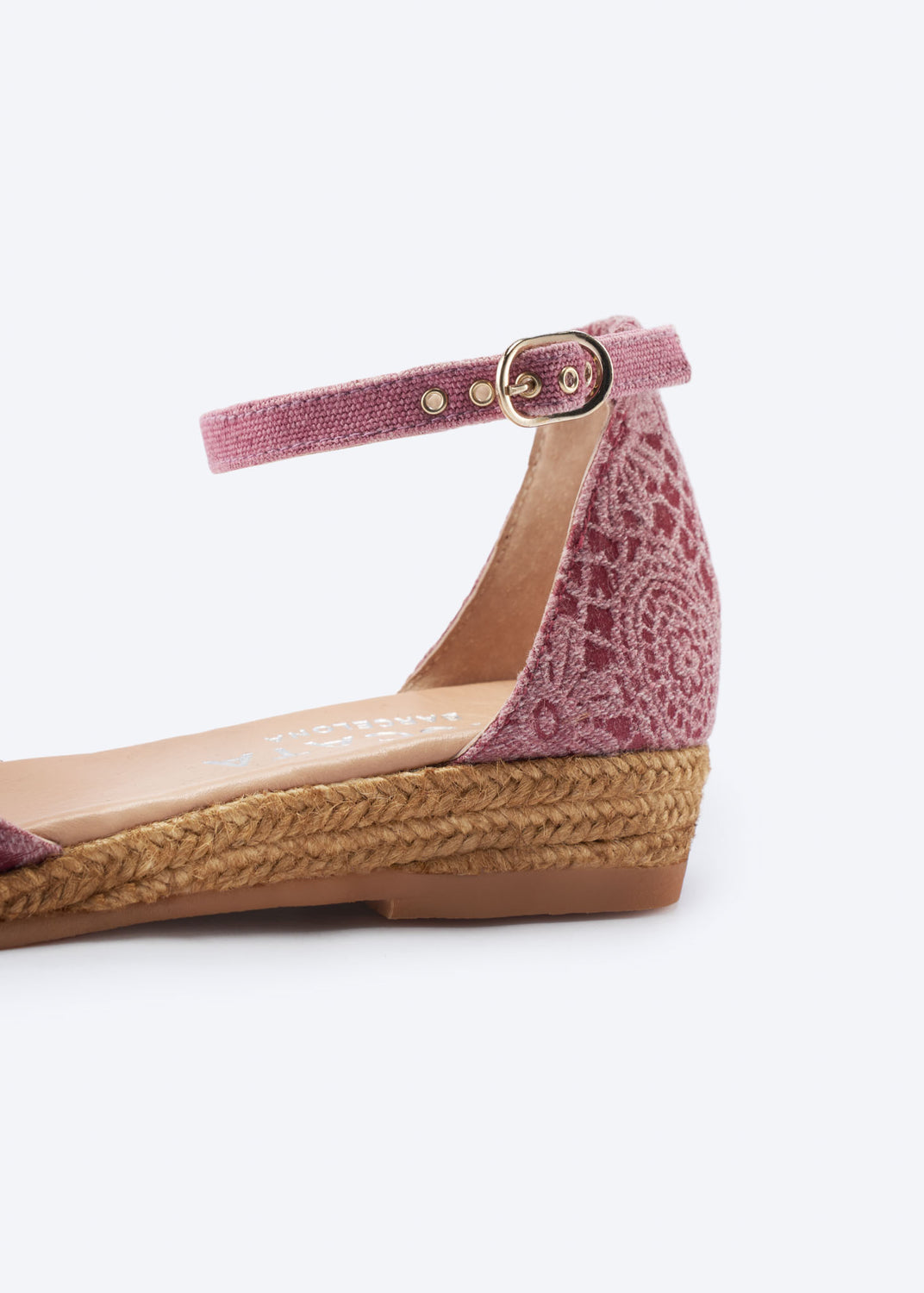 Close-up of pink crochet espadrille flat highlighting ankle strap buckle and braided jute sole.