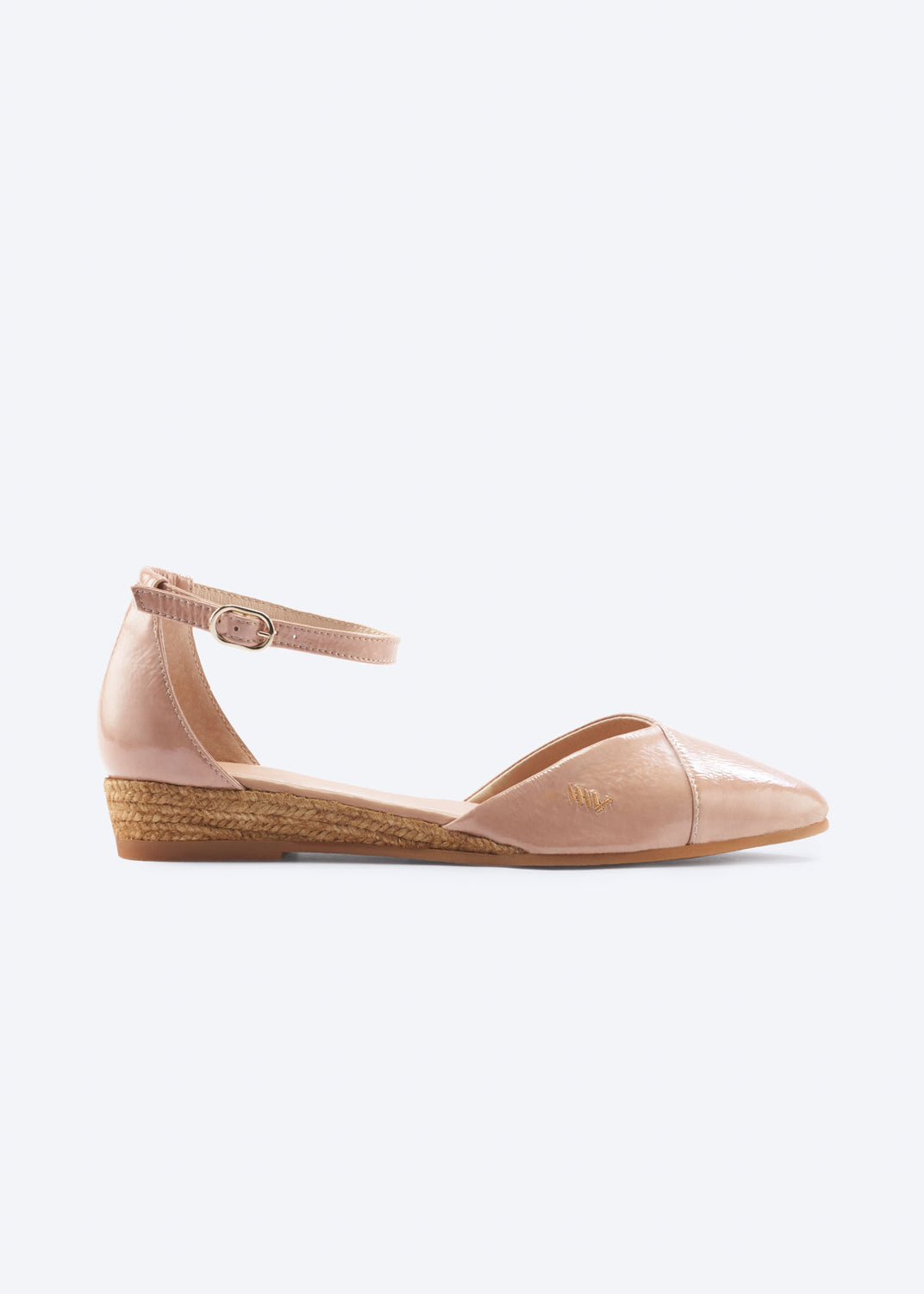 Side view of pink leather espadrille flat with ankle strap and low jute wedge.