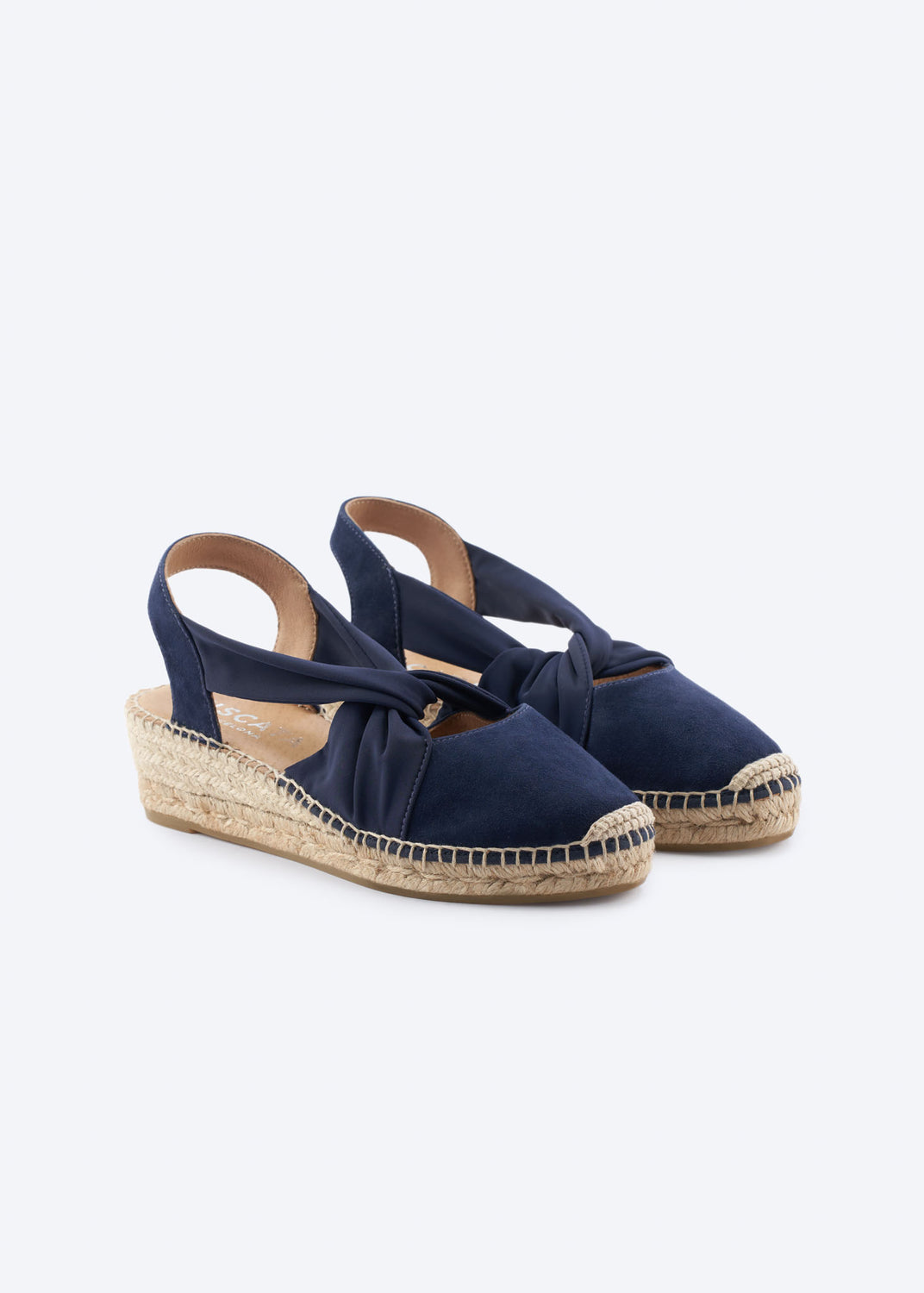 Pair of navy suede slingback espadrille wedges with knot detail.