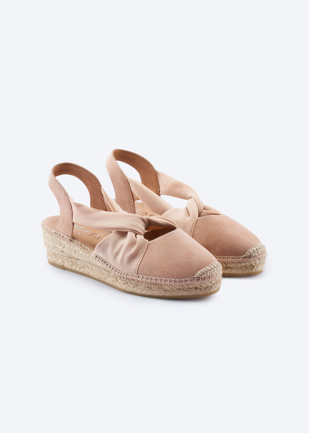 Pair of nude suede slingback espadrille wedges with knot strap.