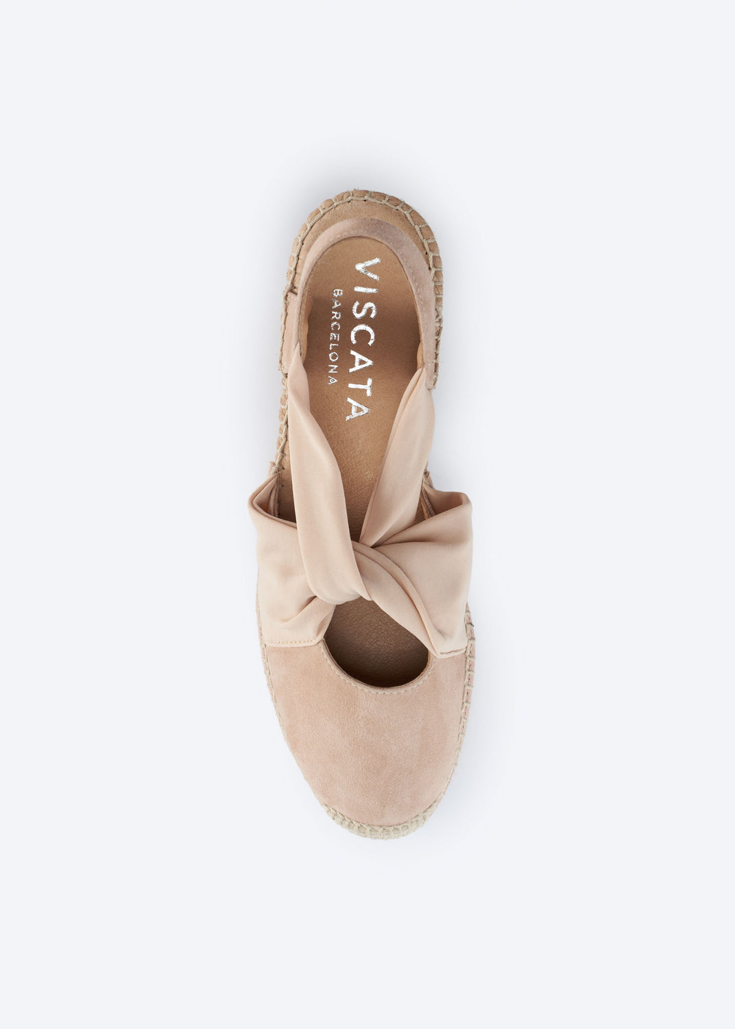 Top view of a nude suede espadrille wedge with knot strap.
