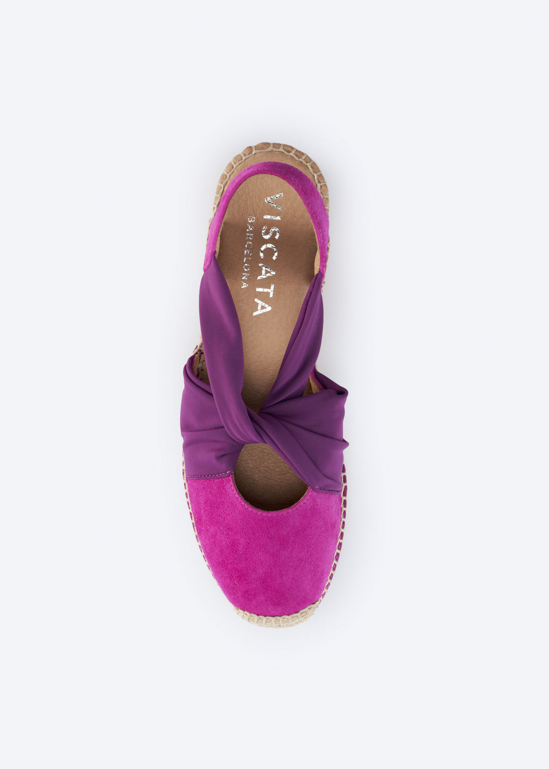 Top view of a fuchsia suede espadrille wedge with purple knot strap.