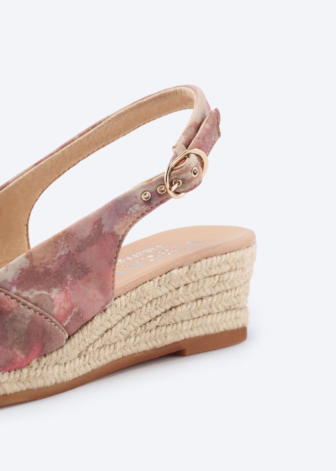 Close-up of pink floral espadrille wedge highlighting ankle strap buckle and braided jute sole.