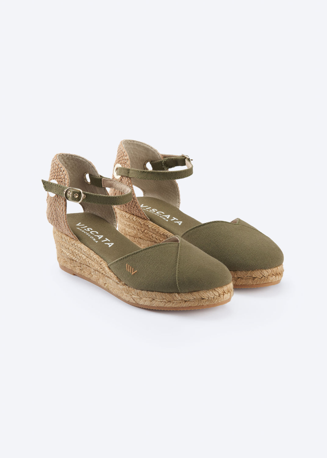 Olive green low wedge espadrille with crossed vamp, ankle straps, and a natural braided jute wedge, handcrafted in Spain