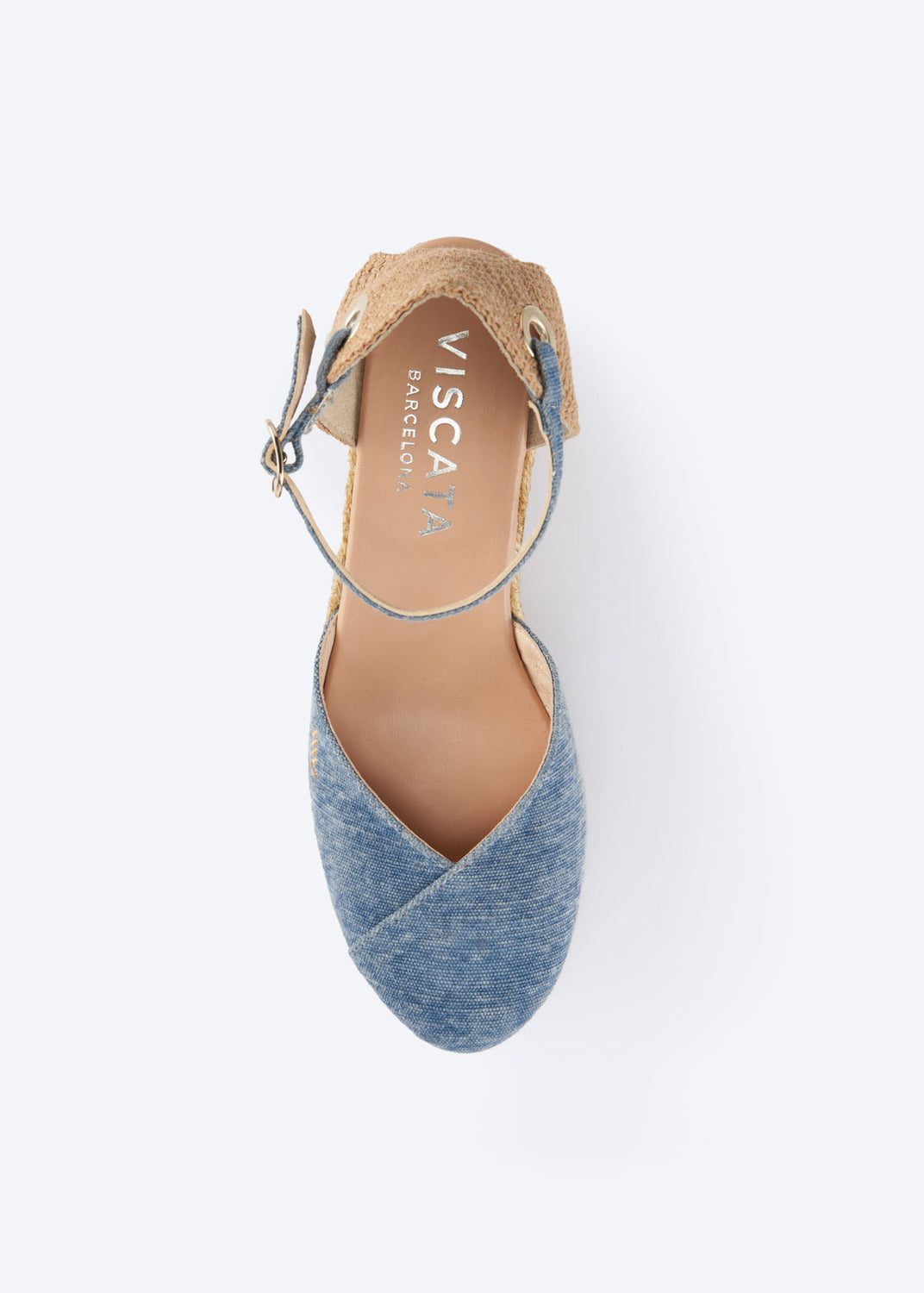 Top view of washed denim espadrille with crossed vamp, ankle strap, and natural braided jute heel, handcrafted in Spain
