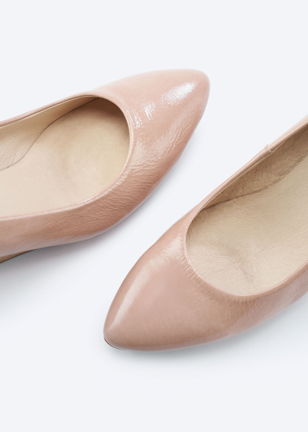Close-up of pink leather espadrille flats highlighting the pointed toe and glossy finish.