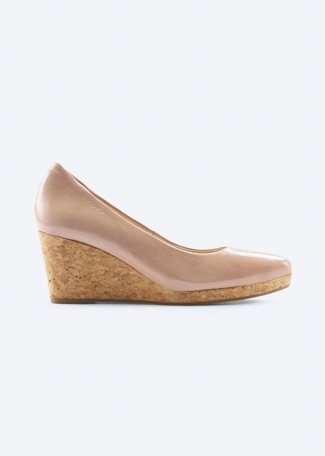 Side view of pink leather wedge shoe with cork heel and smooth glossy finish.