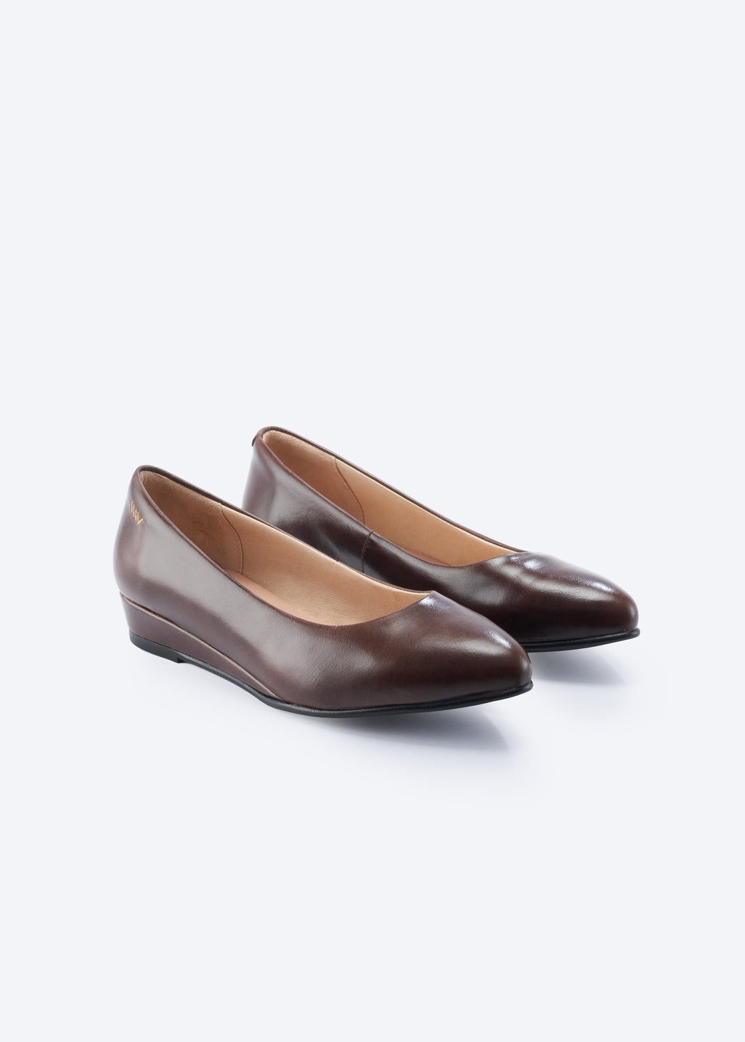 A pair of dark brown leather flats with pointed toes, displayed on a clean white background.