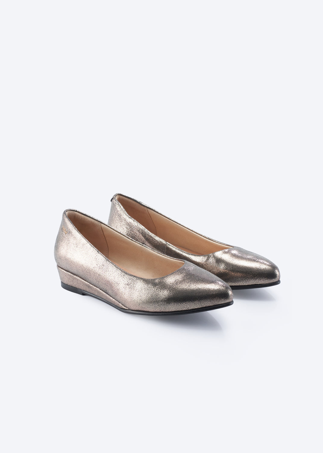 A pair of metallic gold pointed-toe flats with low wedge heels, shown on a clean light gray background.