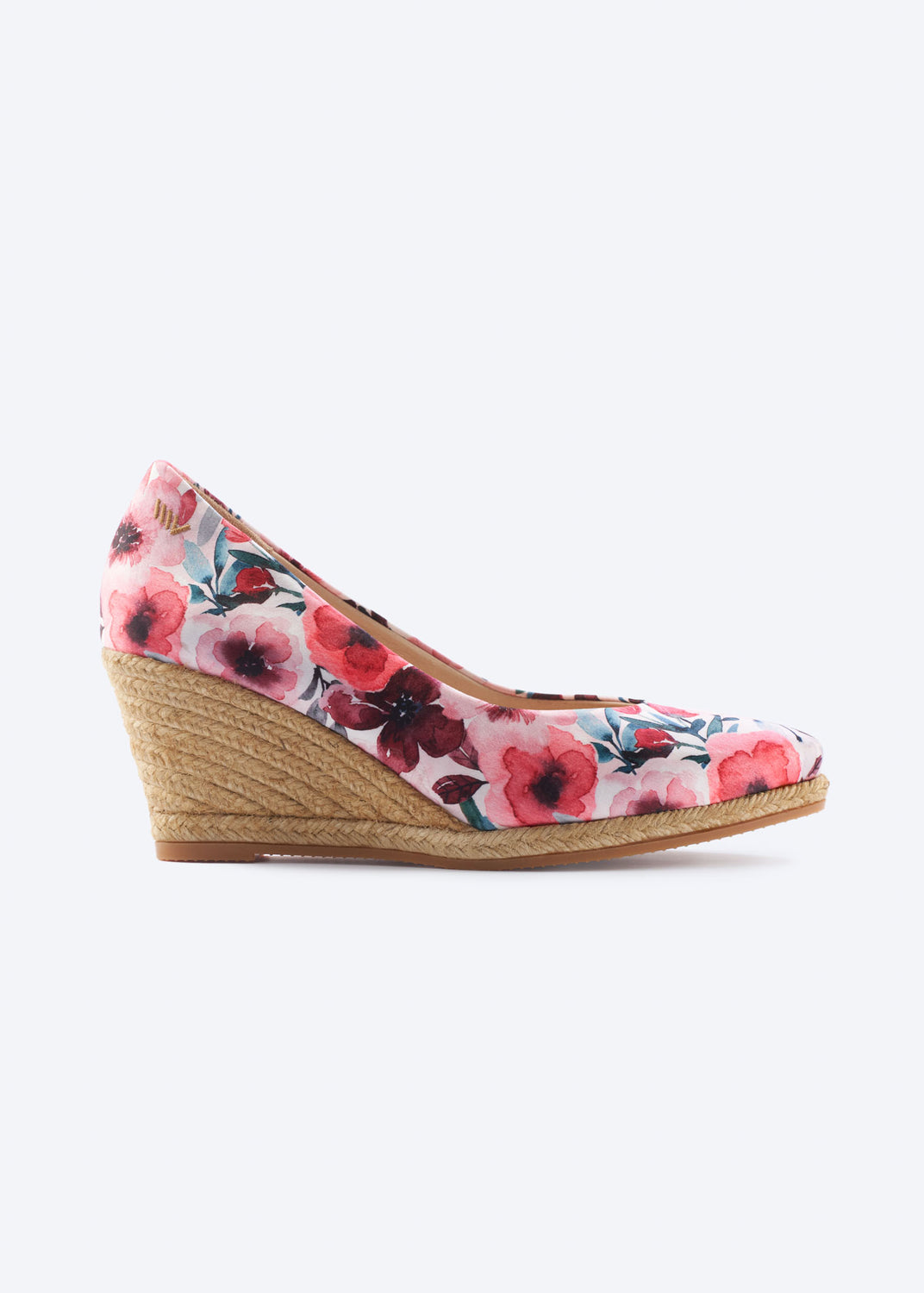 Side view of floral print wedge espadrille pumps with a pointed toe and natural braided jute wedge, handcrafted in Spain