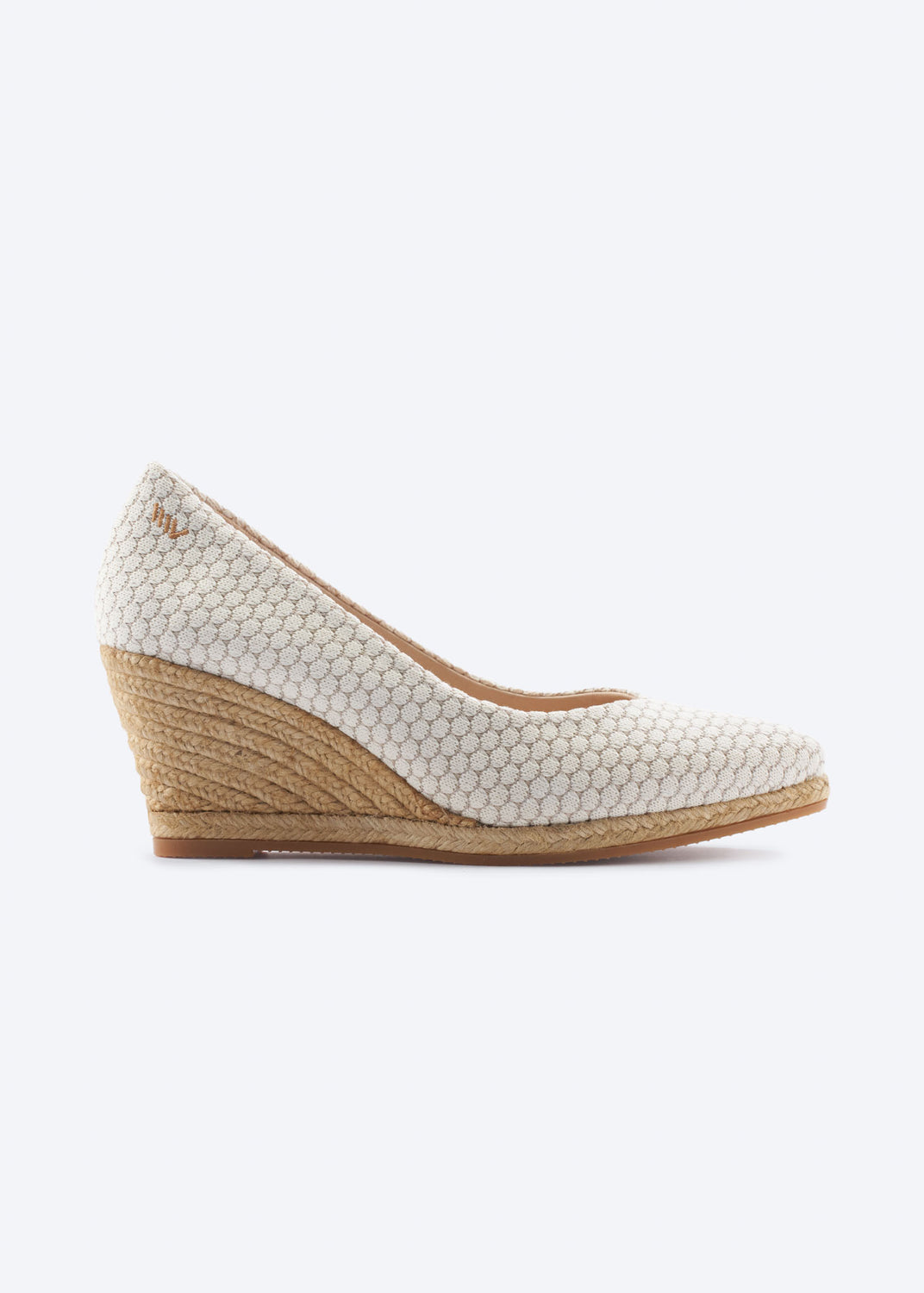 Side view of white mesh wedge espadrille pumps with a pointed toe and natural braided jute wedge, handcrafted in Spain