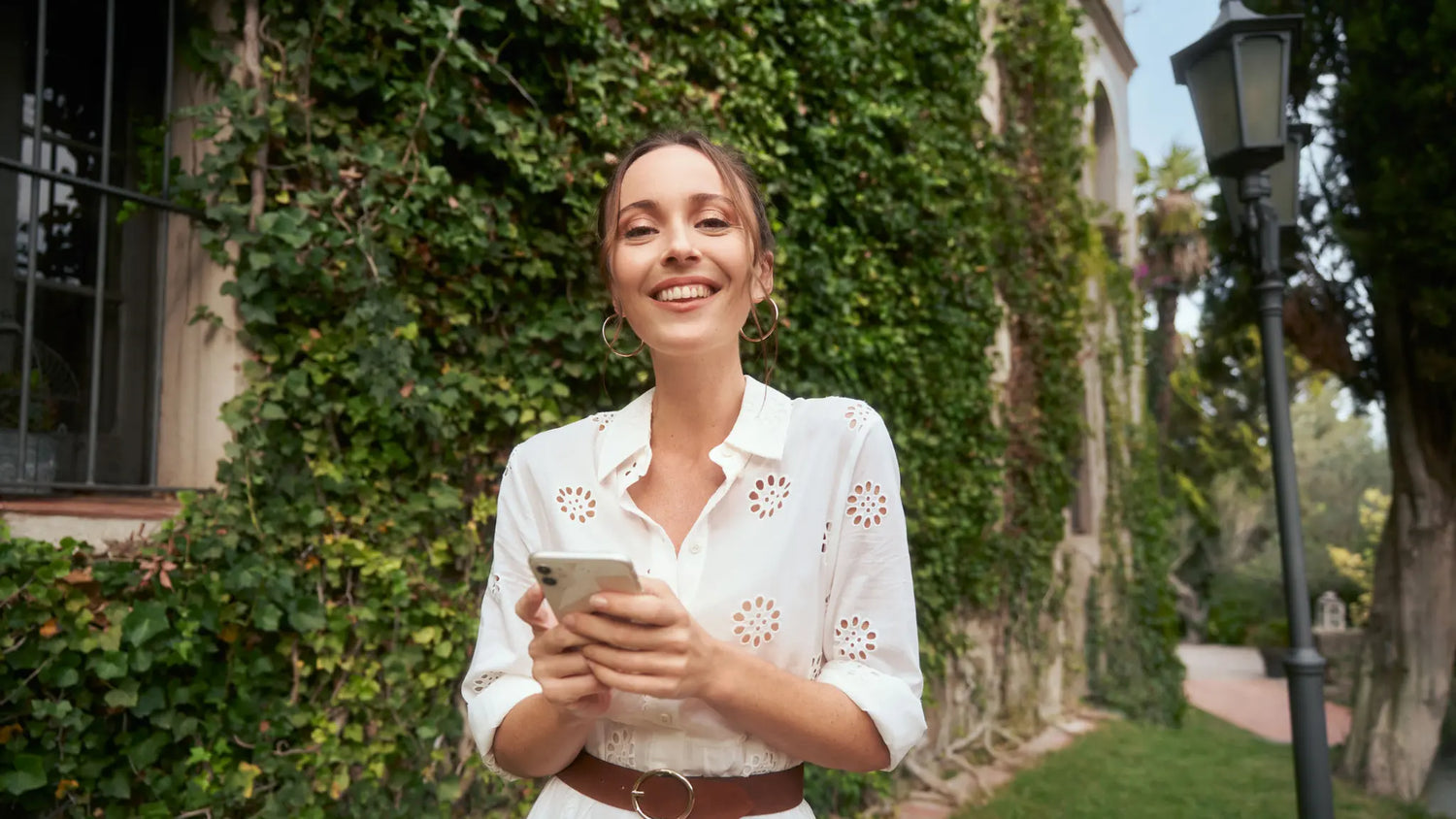 Woman smiling while texting on the phone